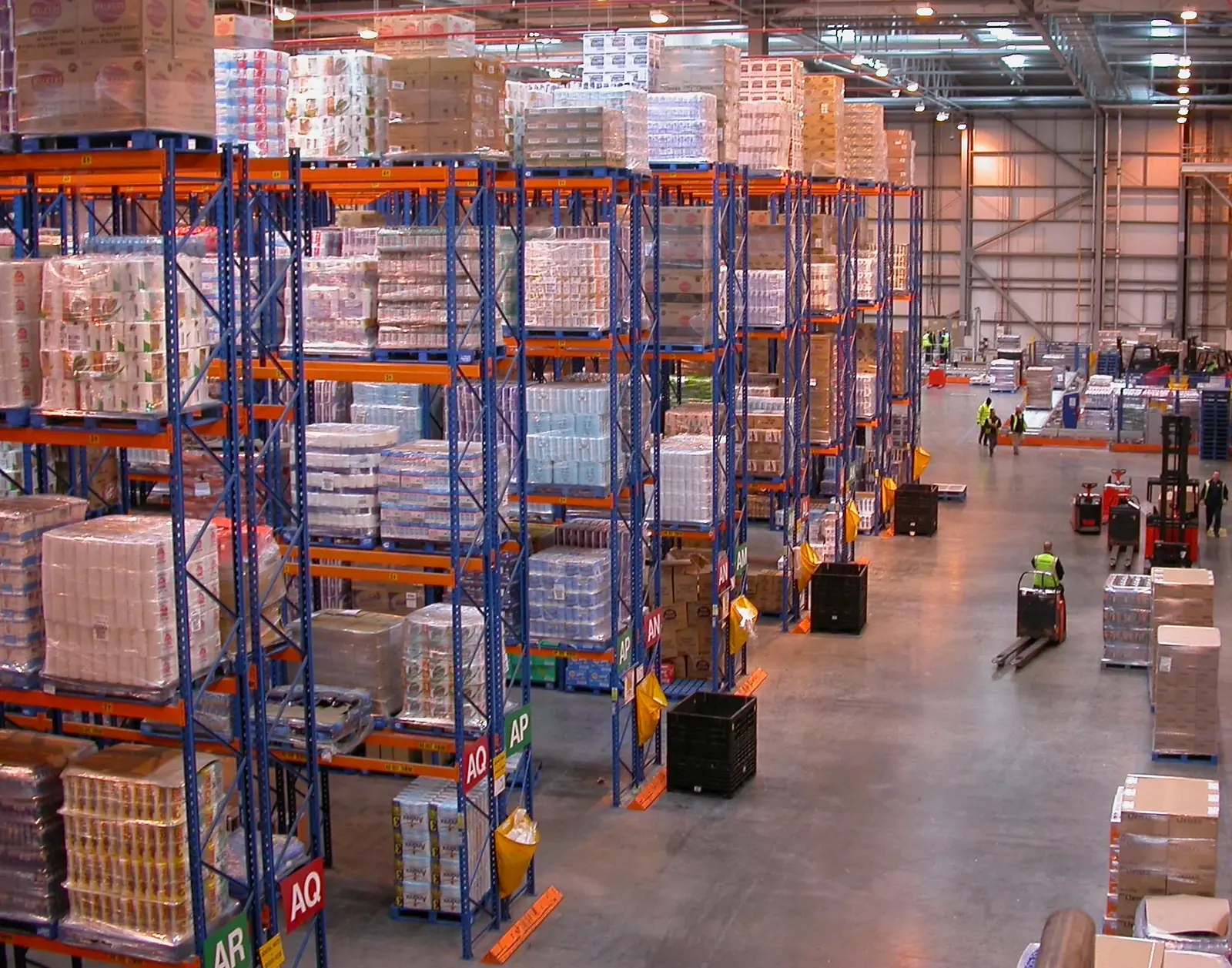 Distribution warehouse with racked pallets and handling equipment